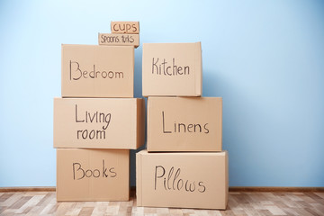 Moving boxes in room on light background