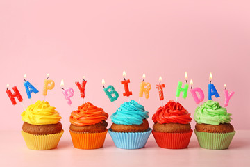 Happy birthday cupcakes on pink background