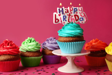 Happy birthday cupcake on stand on red background