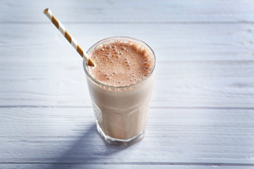 Delicious milkshake on wooden background