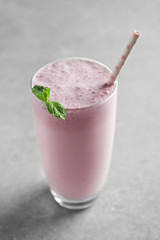 Delicious milkshake on grey textured background