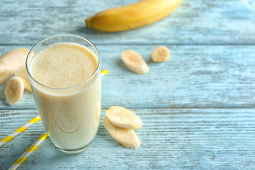 Delicious banana milkshake on wooden background