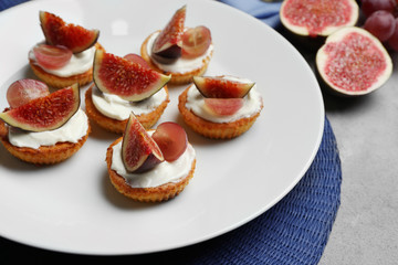 Delicious fig tarts on plate, closeup