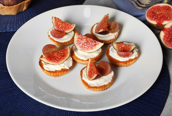 Delicious fig tarts on plate
