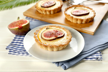 Tasty cakes with figs on wooden board, closeup