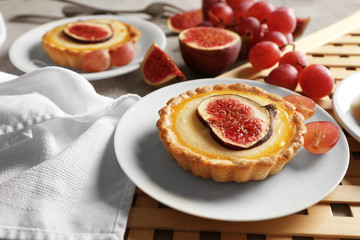 Tasty fig cakes on plates, closeup