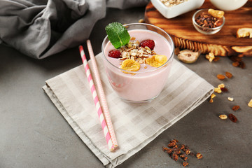 Healthy and tasty breakfast of berry milkshake with oatmeal and mint on napkin