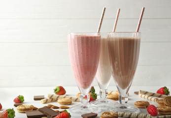 Tasty cocktails with berries and sweets on table