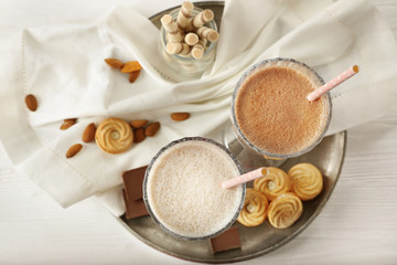 Tasty cocktails and sweets on tray, top view