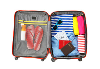 Open suitcase with traveller set on white background