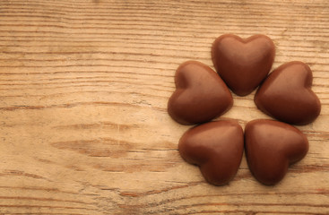 Chocolate hearts on wooden background