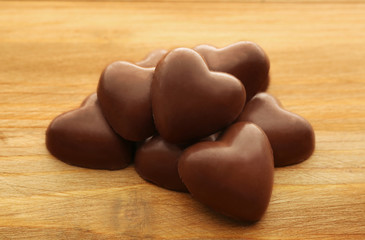 Chocolate hearts on wooden background