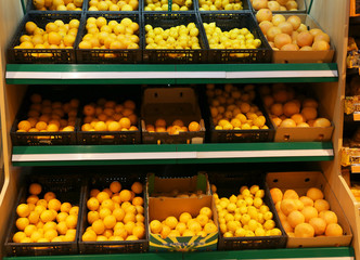 Boxes with fresh citrus fruits in supermarket