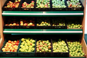 Boxes with fresh apples in supermarket