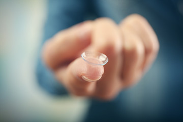 Contact lens on female finger, close up view. Medicine and vision concept
