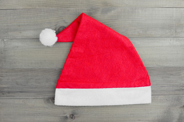 Obraz na płótnie Canvas Christmas hat on vintage wood background