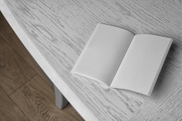 Blank open brochure on wooden table