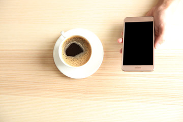 Man using smart phone in cafe