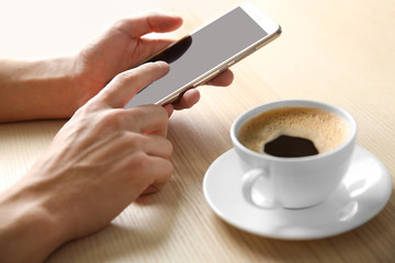 Man using smart phone in cafe