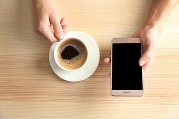 Man using smart phone in cafe