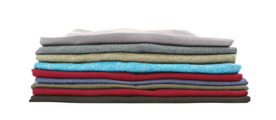 Stack of colorful t-shirts on white background
