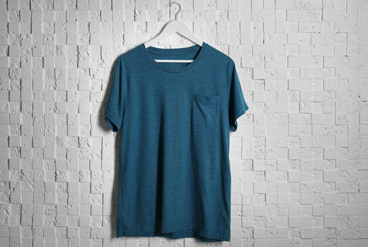 Blank color t-shirt against light textured background