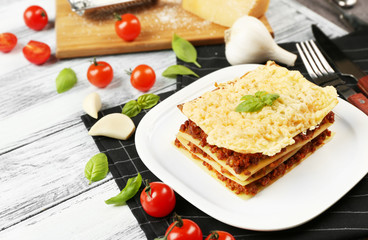 Homemade meat lasagna on white wooden table