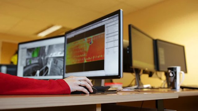 Woman's hand holding a mouse for office design work. Female architect or engineer designing building