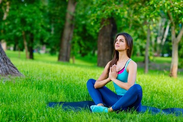 Fototapeta premium Yoga woman on green grass