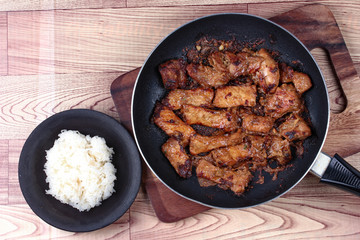 Grilled pork with mixed herb served sticky rice .