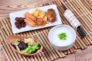 Fototapeta na wymiar Rice gruel with sausage,clams,radish ,omelet and fried vegetable