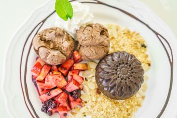 Chocolate cake with fruit peach, black currant, blueberry, apple