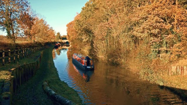 autumn exterior narrow boat sailing on canal: Church Eaton, Stafford, England-November 2016