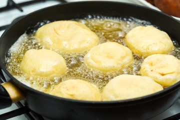 Donuts frying in deep fat
