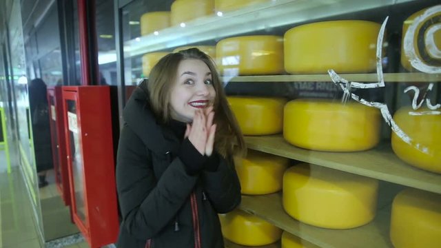 Girl at the showcases with cheese