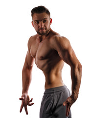 Fototapeta na wymiar Bodybuilder posing on a white background. Athlete isolated. Drying. Relief and sculptural muscles of the body. Concept of healthy lifestyle. Beauty male body.