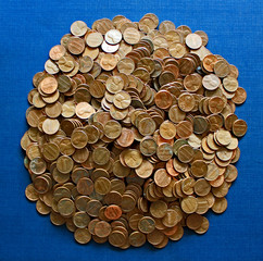 Pile of old pennies on blue background