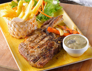  Pork chop steak on the table.