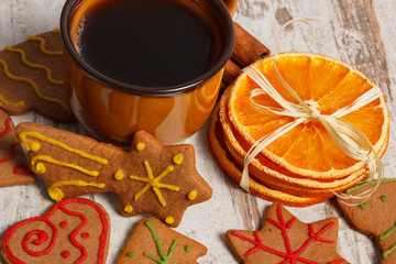 Fresh gingerbread, cup of coffee and spices on old wooden background, christmas time