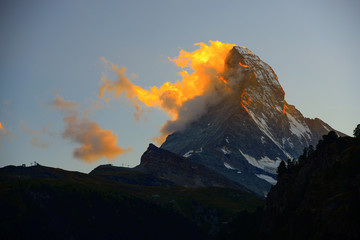 Matterhorn in early morning with alpenglow and cloud on peak in