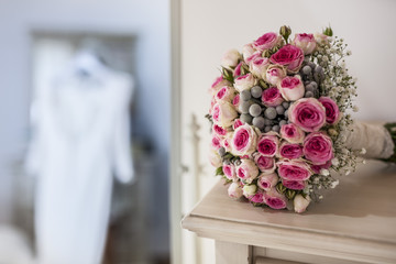 Wedding dress and bouquet in the bedroom
