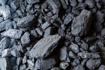 Black coal lying on a pile in house basement