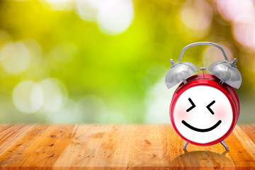 Red smile alarm clock with blurred background 