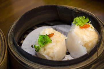 Dimsum in bamboo containers with soy sauce