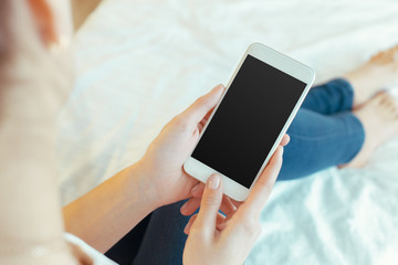 Woman with modern mobile phone in hands