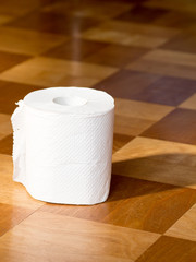 Toilet paper on the wooden floor
