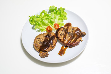 pork steak with salad isolated in white background
