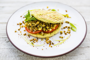 Herbal pita breads with tomato and fresh sprouts. Vegetarian food and healthy diet.