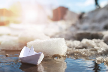 paper boat in a pool winter