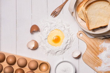 Egg in flour. Making dough background. Baking with raw eggs, sug